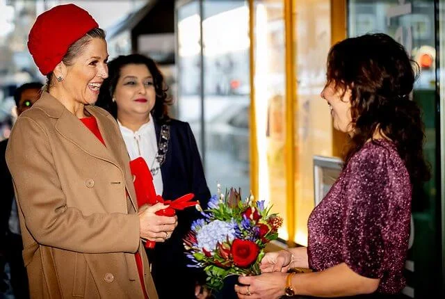 Queen Maxima wore a madame camel, wool and cashmere belted coat by Max Mara, and a red midi dress by Natan