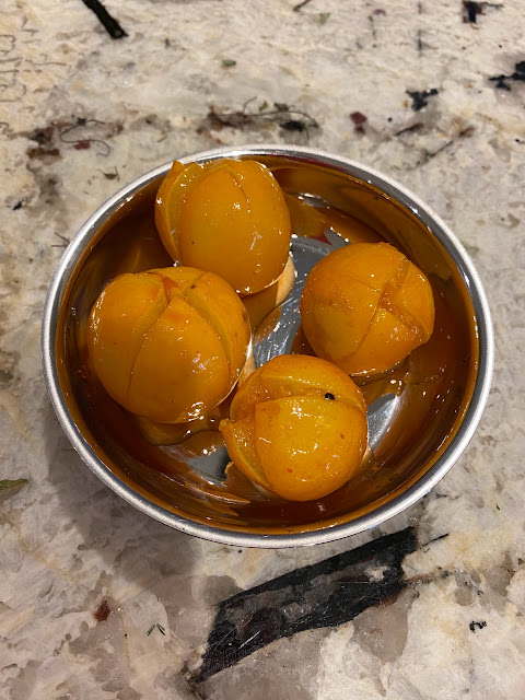 small metal bowl with 4 pickled lemons