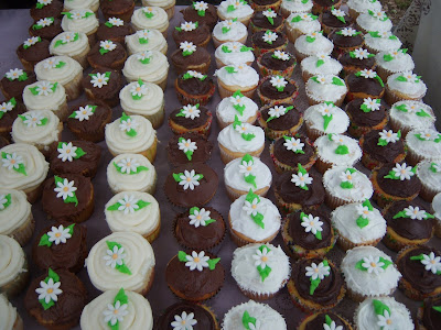  240 daisies from gum paste and royal icing to top each of the cupcakes