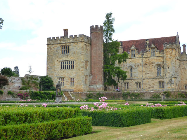 Pink roses and green hedges in the Italian Garden, with Penshurst Place building in the background
