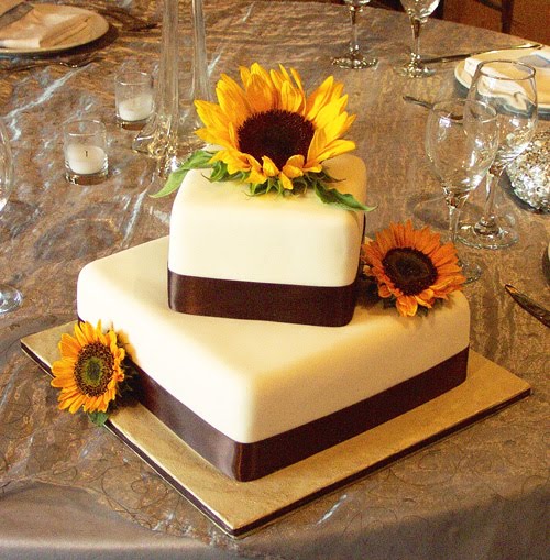 Elegant two tier square wedding cake with sunflowers