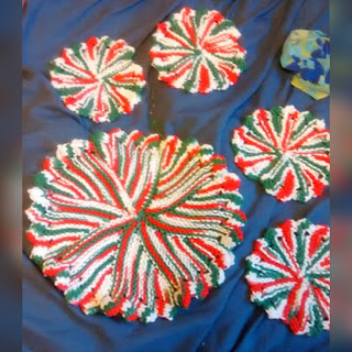 A trivet and 4 coasters knit in garter stitch short rows with petal-type edges.