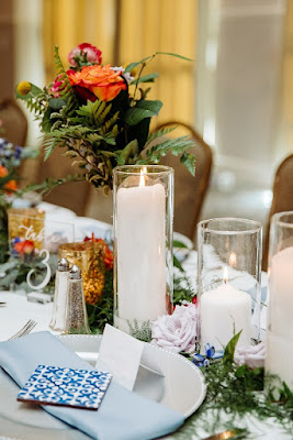 reception table centerpieces in vases with pillar candles