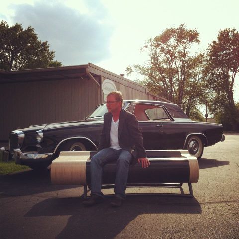 Christopher West Curator chilling with a bad ass bench and 1962 Studebaker