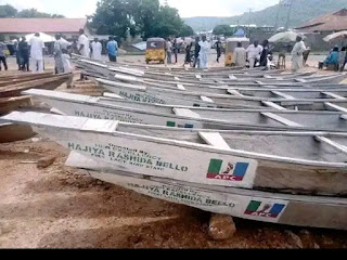 NIGERIANS REACT AS  GOVERNOR BELLO'S  WIFE OF KOJI STATE  PROVIDES LOADS OF WODEN CANOES, SAYS IT WILL HELP THE YOUNG MEN TOWARDS EMPOWERMENT