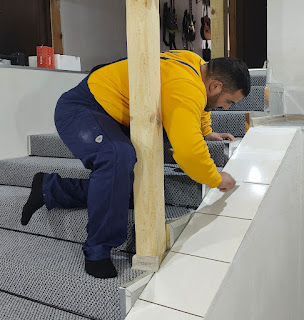 Halil works on the grout for these tiles