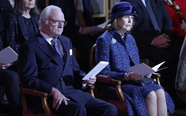 Queen Silvia wore a blue tweed coat and a blue tweed dress by Chanel. Georg et Arend dress. Archbishop Martin Modeus