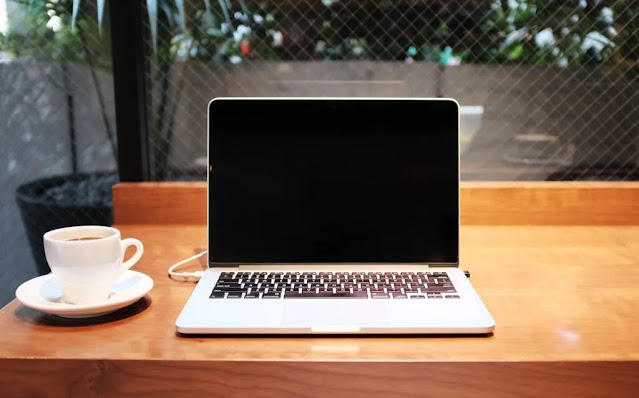 macbook with coffee in morning