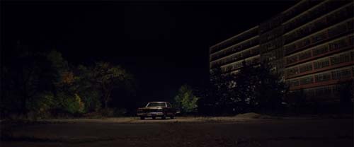 A lone car in a dark parking lot in It Follows