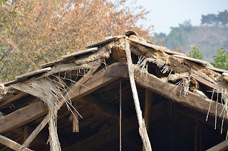 Tile, mud, thatch roof construction at ceramics factory in Beijing