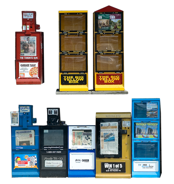 A variety of newspaper vending boxes, of the type usually found outside public places, and on streetcorners.