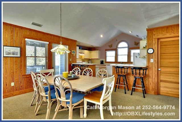 Share great stories with your loved ones on this Outer Banks NC home for sale's spacious dining area. 