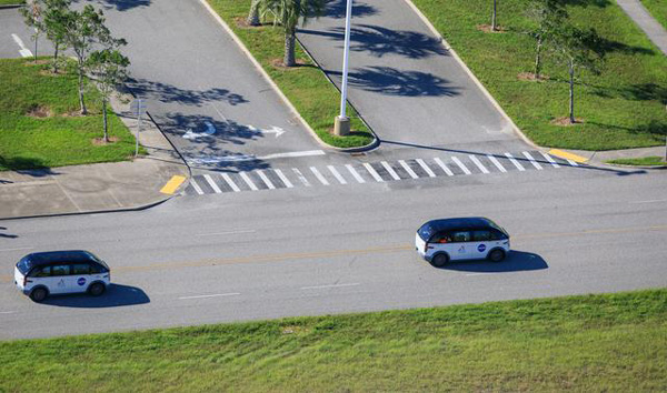 The two electric vehicles carrying the Artemis 2 astronauts head towards Kennedy Space Center's Launch Complex 39B in Florida...on September 20, 2023.