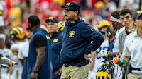 Jim Harbaugh watches his team