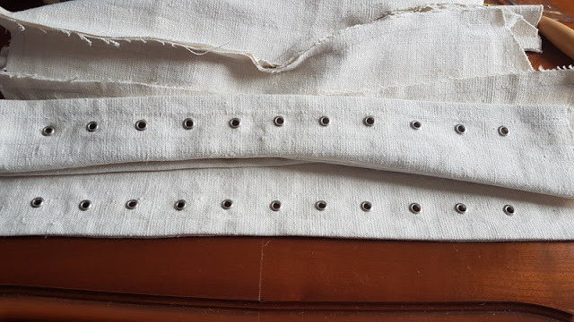 Edwardian corset with all of the eyelets punched into it on both sides