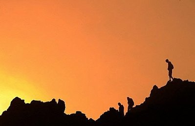 sunset behind hikers in silhouette