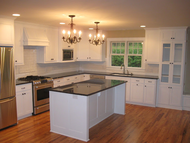 white painted kitchen cabinets with lighting and icebox