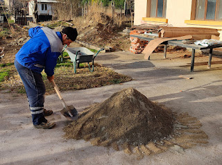 Bekir starts mixing up cement for the day