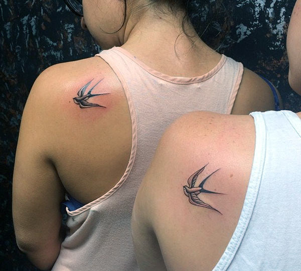 That's so cool and pretty matching birds tattoo designs on the left upper back for sisters.