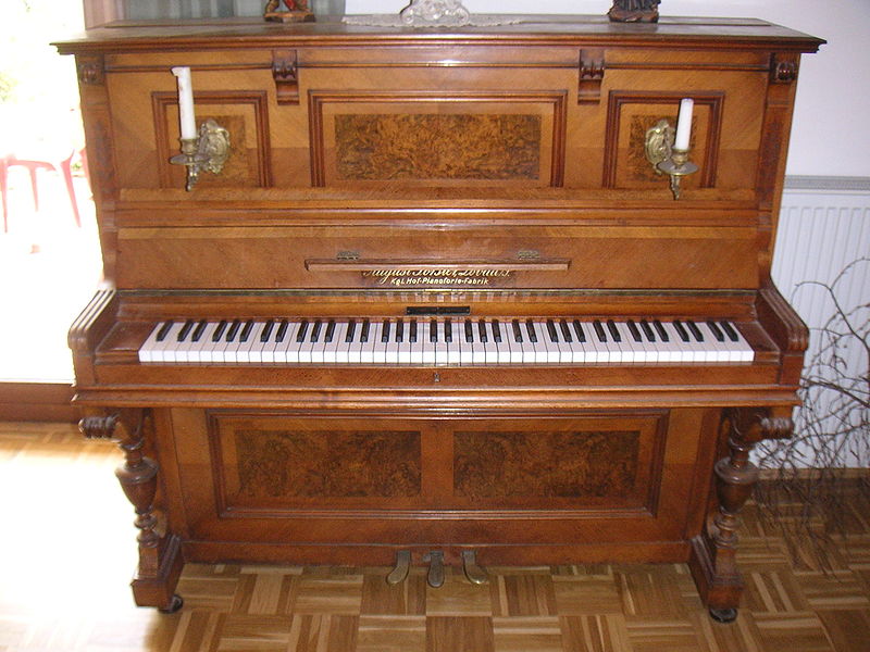 Upright piano by August