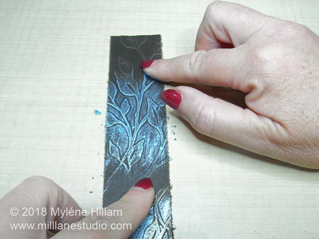 Applying the metallic wax to the embossed detail of the leather