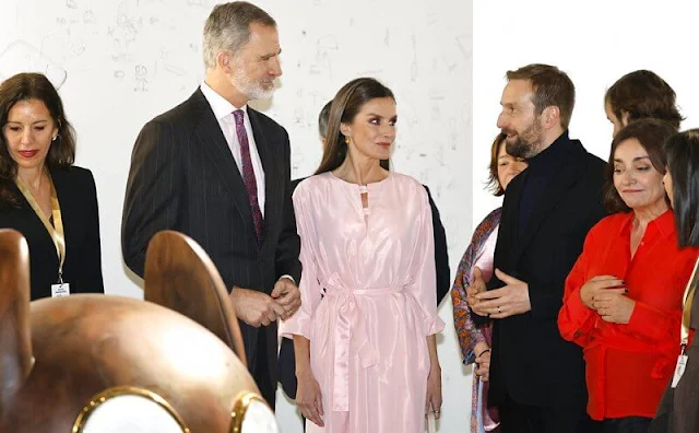 Queen Letizia wore a new rose midi shirt dress by Moises Nieto. Cashfana Babidi earrings. Furla floral pattern mini handbag