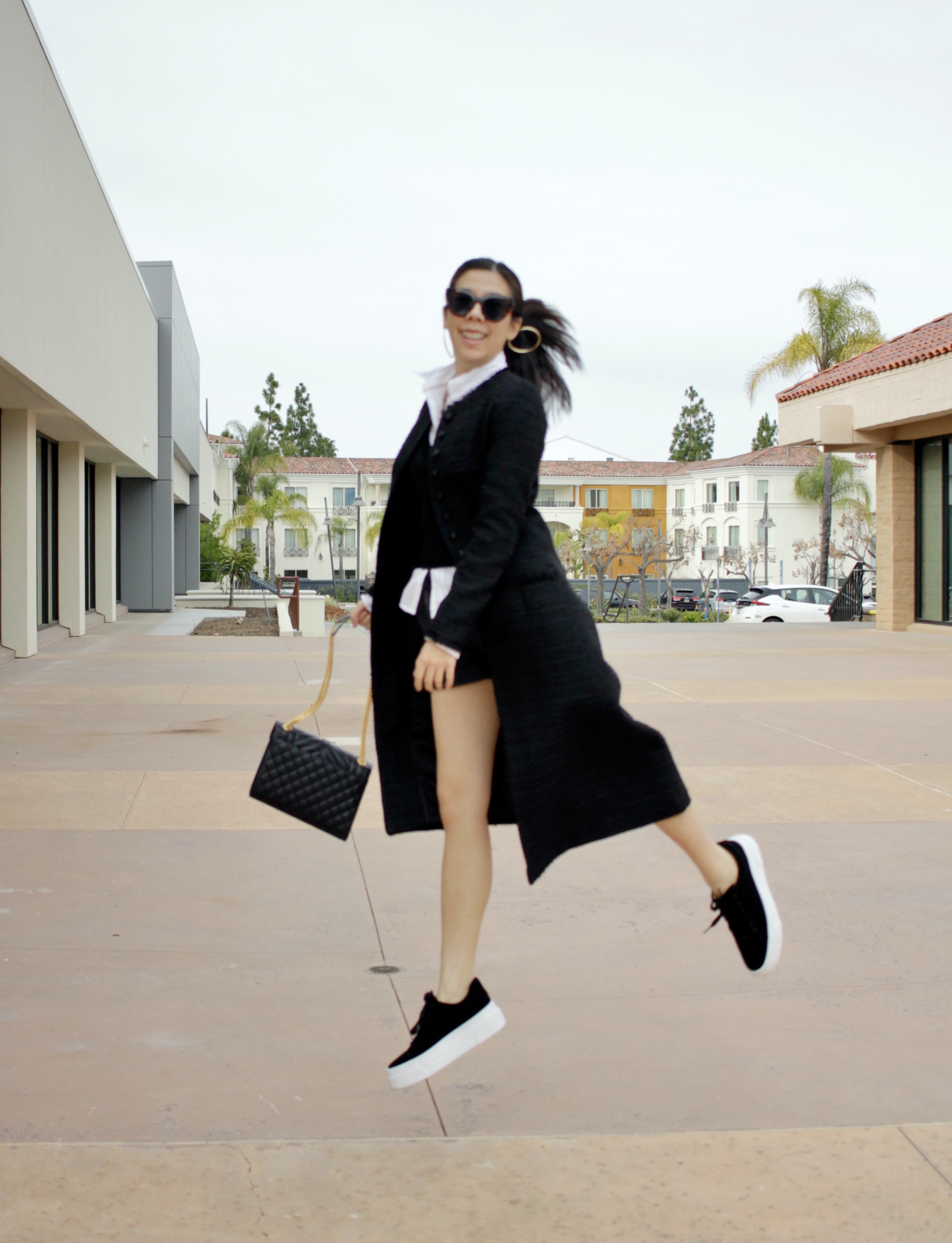 Adrienne Nguyen_Minimalistic Basic Black and White Outfit for Fall with a Tweed Coat, Sweater Vest, Preppy Inspo, White Collar Button Down, Leather Shorts and Suede Platform Sneakers