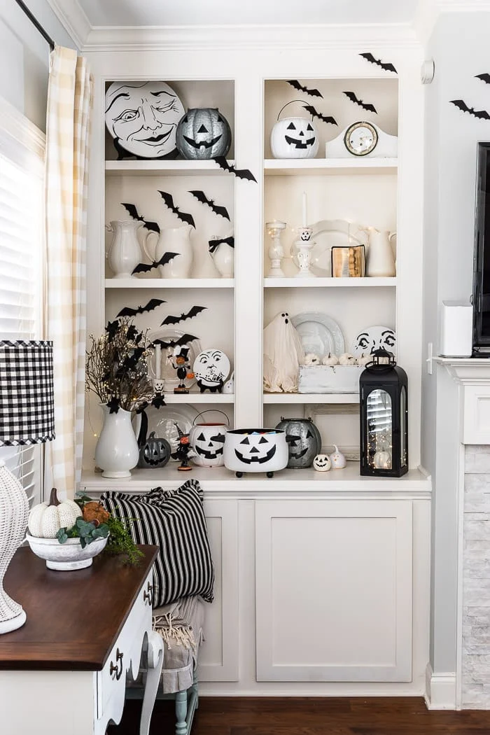 bookcase filled with black and white Halloween decor