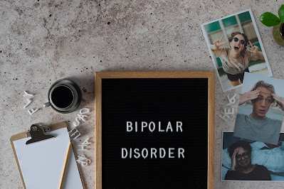 bipolar disorder written on blackboard surrounded by pictures of emotions