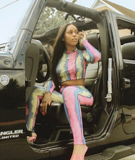 Bahja Rodriguez posing for photo sitting in Jeep