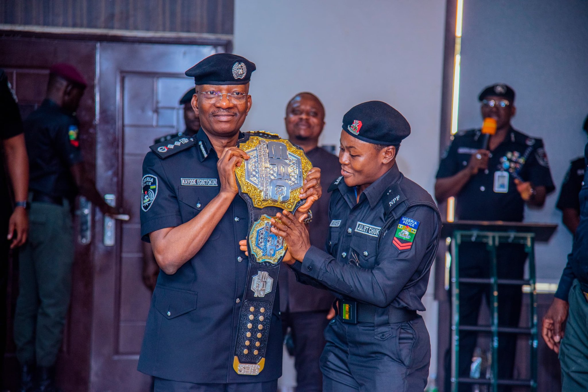 Cpl Juliet, World Champion in MMA, takes a shot with IGP Kayode Egbetokun