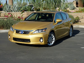 Front 3/4 view of gold 2011 Lexus CT 200h Hybrid parked in resort setting