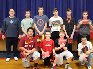 Group of students and their teacher posing for a picture holding awards from Hoops for Hearts