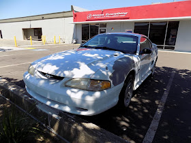 Peeling paint on 1998 Ford Mustang prior to repainting at Almost Everything Auto Body.