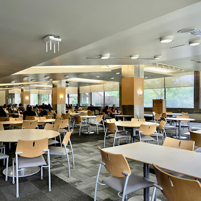 People sit at tables in the Redwood Campus Student Center.