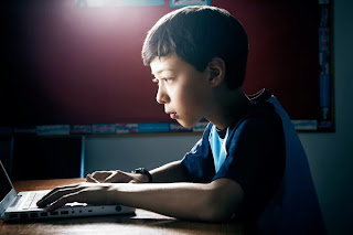 Picture of 10 year old Matthew Carpenter at his computer on KhanAcademy.org learn trigonometry problems