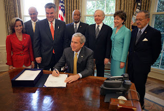 President George W. Bush signs into law H.R. 1, Implementing Recommendations of the 9/11 Commission Act of 2007, Friday, August 3, 2007, in the Oval Office. White House photo by Eric Draper.