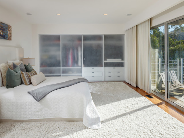 Picture of modern bed in the bedroom, looking towards the window
