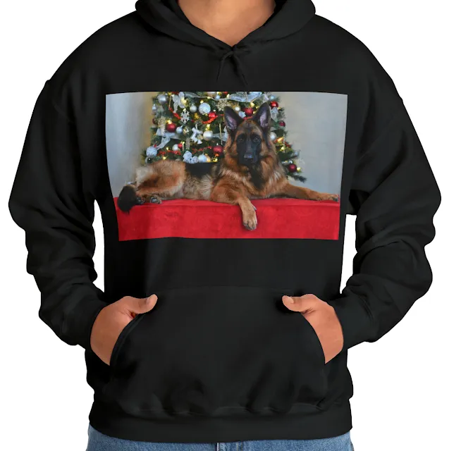 A Hoodie with Black and Red German Shepherd Lying in Front of Christmas Tree Heavy Blend™ Hooded Sweatshirt