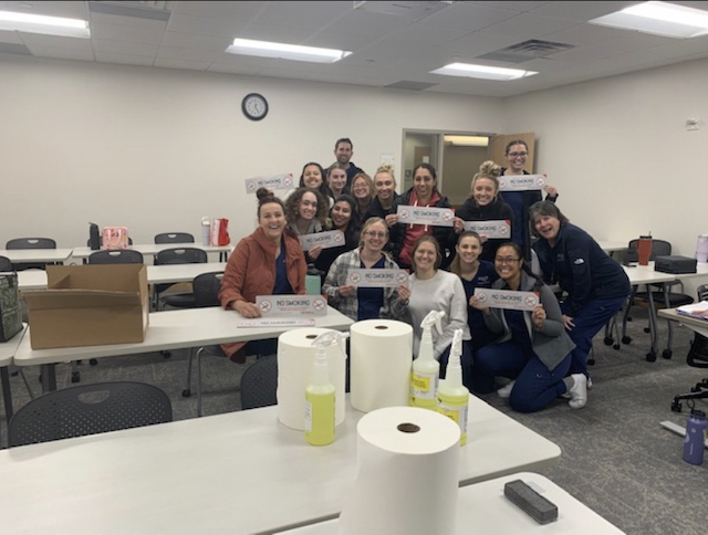 SLCC Dental Hygiene students are being trained on the proper way to post up tobacco signage
