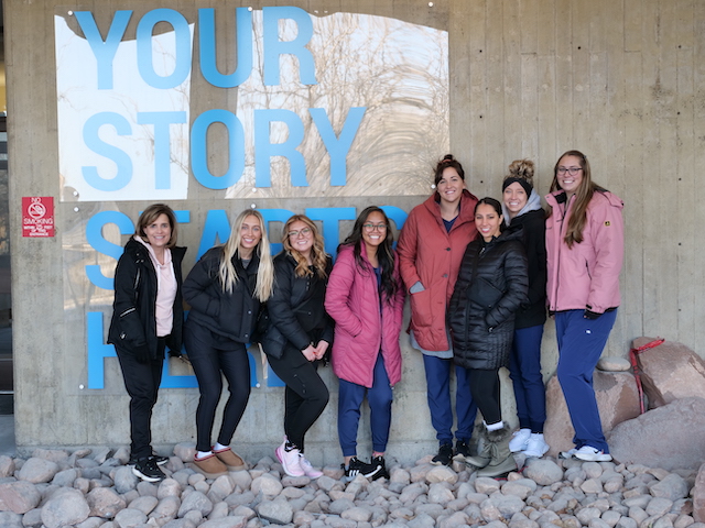 Part of the Dental Hygiene group posing for a picture in front of the Student Center at the Taylorsville Redwood Campus