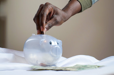 Putting a coin in a piggy bank