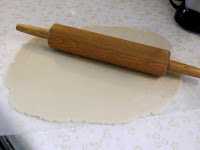 homemad and rolled out pie crust on plastic board