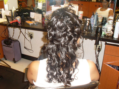 A half up half down style of cascading curls