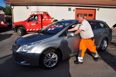 pushing the car into the service bay