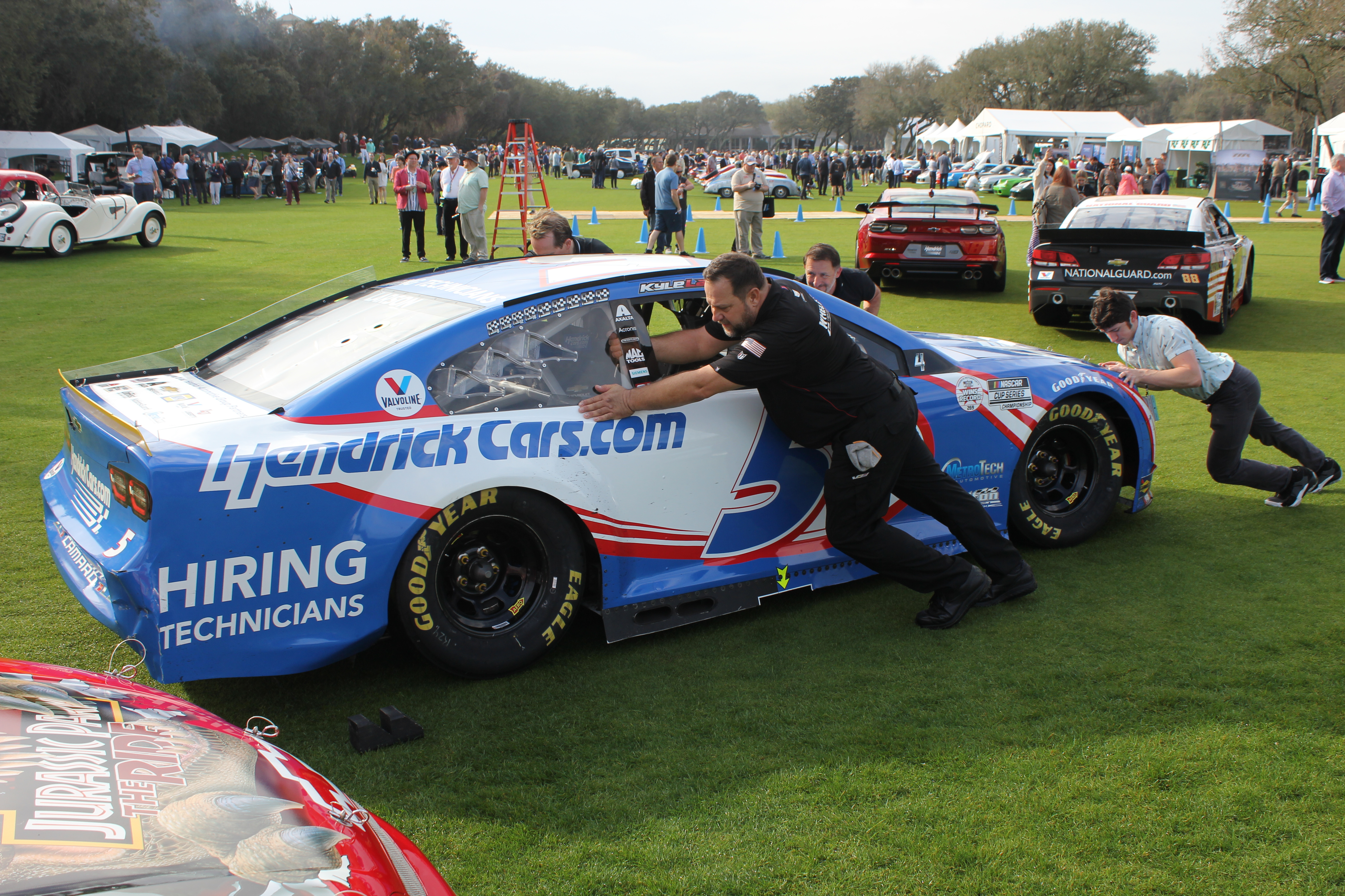 Saturday night rain forced last-minute Sunday morning  ‘stagging’ of honoree Rick Hendrick’s race cars.