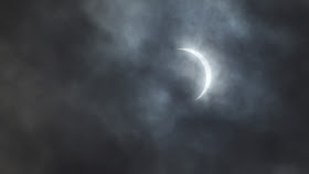 crescent sun in clouds