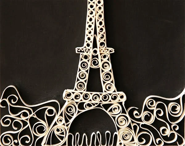 quilled eiffel tower on black background