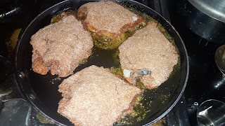 Place the coated pomfret on frying pan