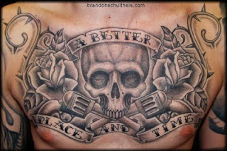 skull and guns tattoo covering a men's chest